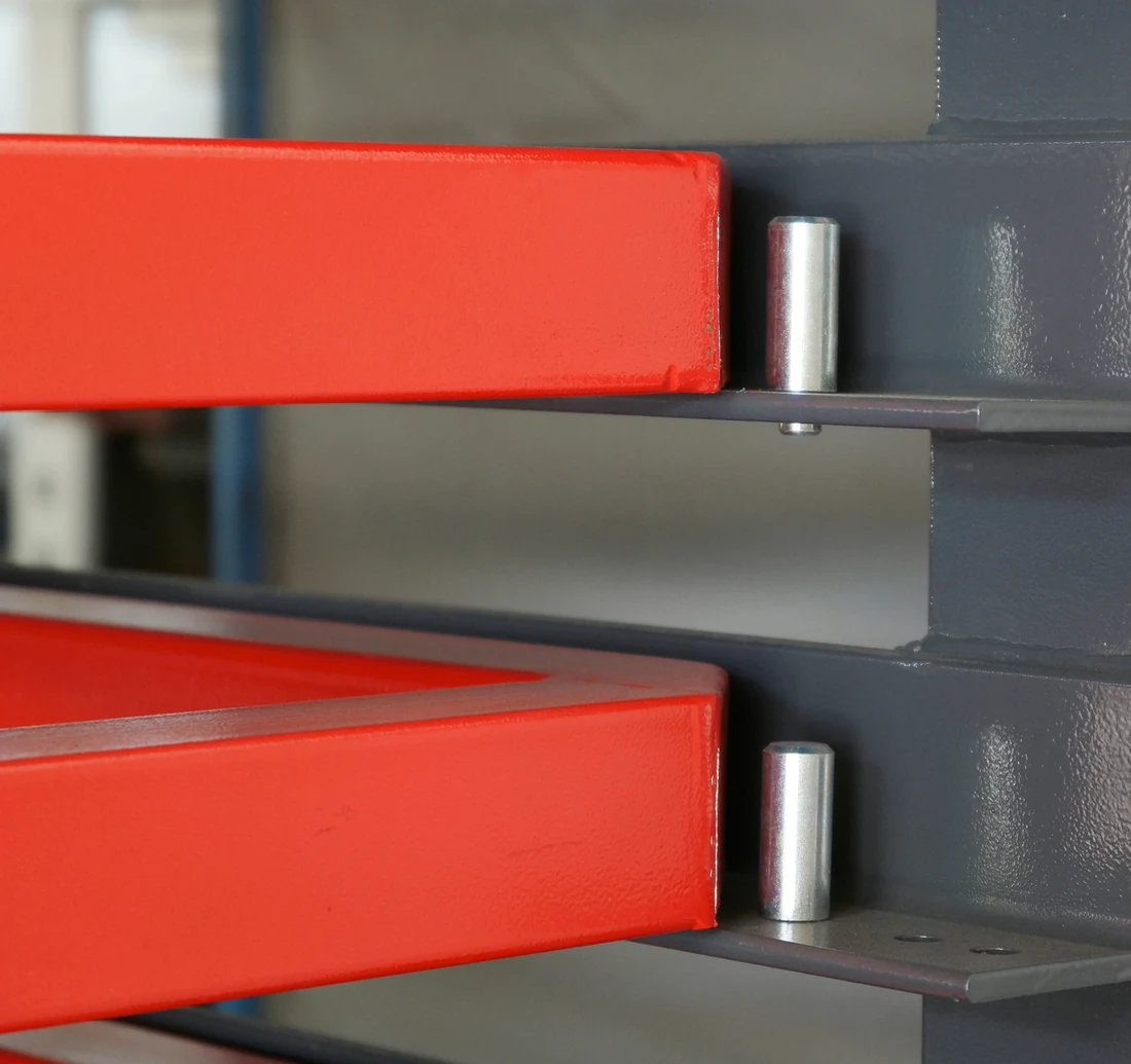 Close-up of two turned steel stop pins seated in the P-RACK upright